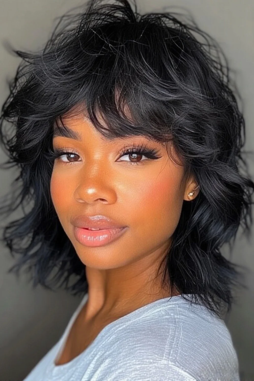 Wispy natural bangs paired with face-framing layered haircut.
